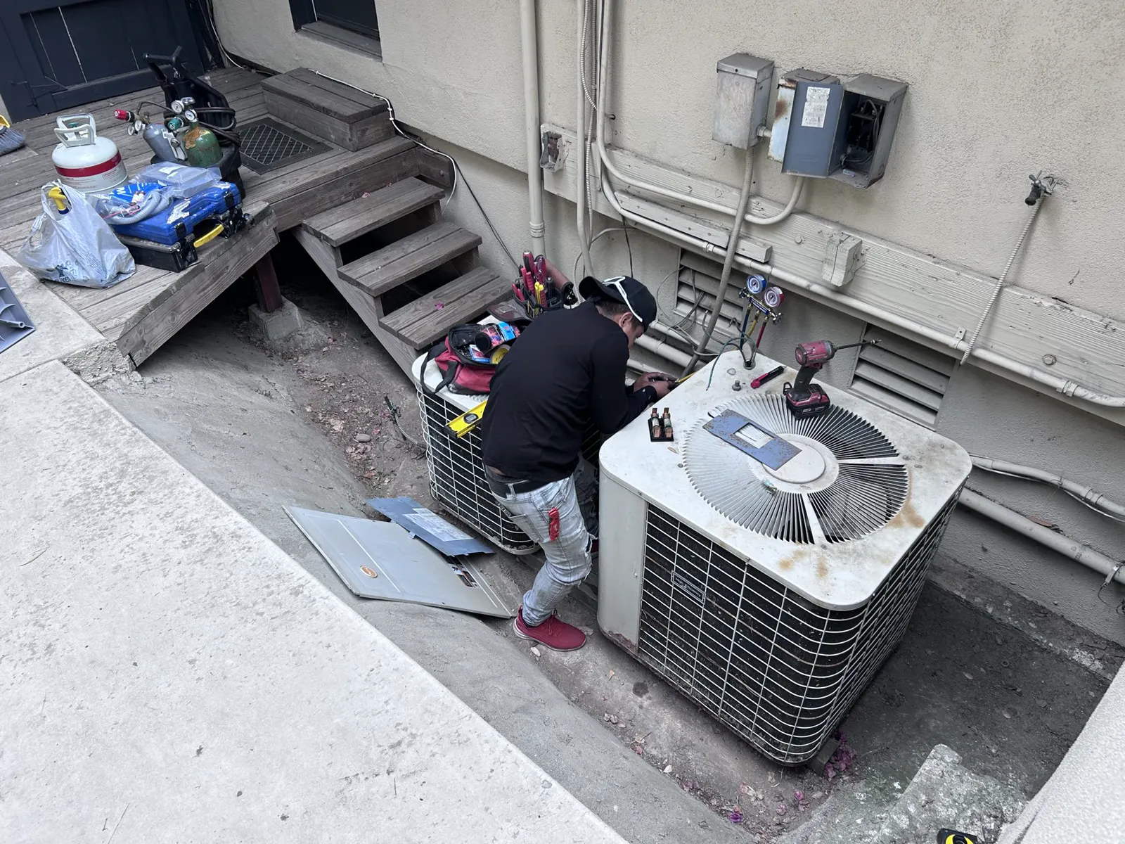 Technician working on a condenser change-out